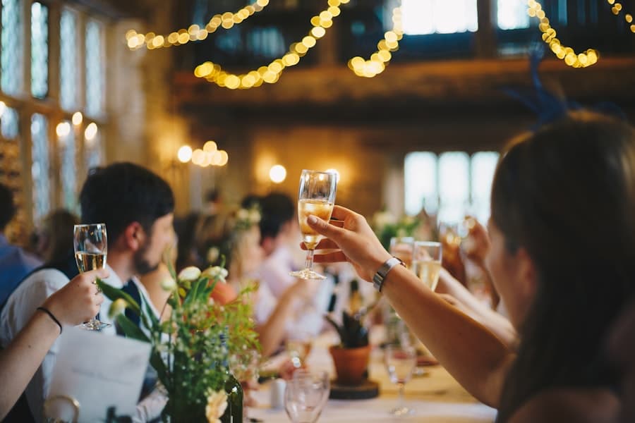 Guests raising glasses under string lights